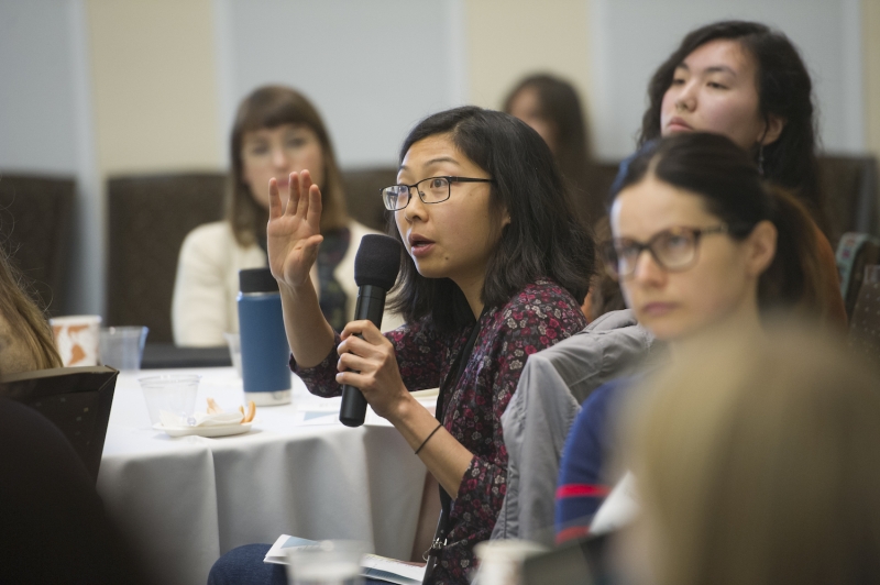 Participants ask questions at the Feminist Research symposium