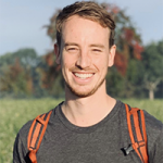 Head and shoulders of smiling man with shoulder straps